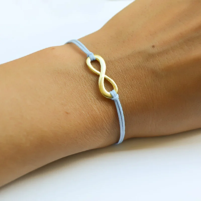 Blue cord bracelet with a gold tone infinity endless charm, handmade mothers day gift, preppy jewelry