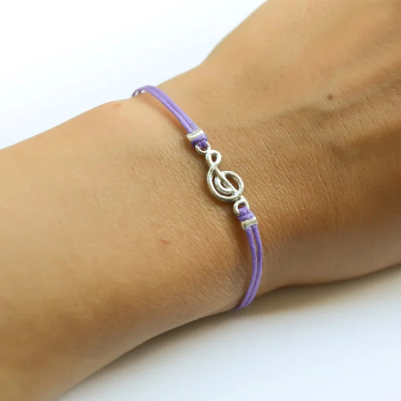 Purple cord bracelet with a silver Treble clef charm, music note jewelry