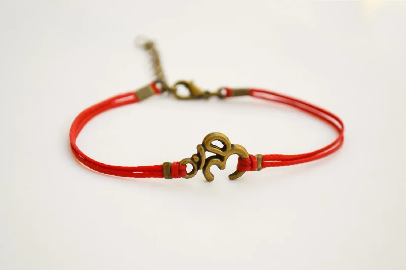 Red bracelet with bronze tone Om charm, yoga jewelry