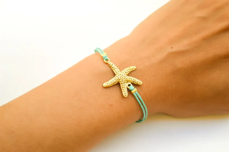 Turquoise cord bracelet with a gold starfish charm