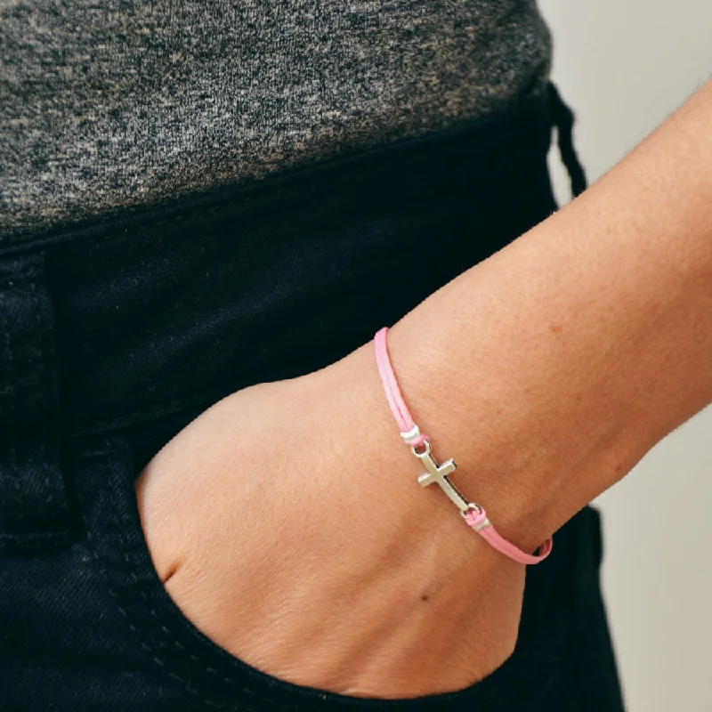 Women bracelet with silver cross charm, pink cord